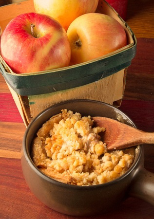 Photograph of a basket of red and yellow apples representing healthy holiday food including Apple crisp