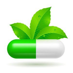 White and green capsule with green leaves as used in the practice of Chiropractic, Holistic, Alternative Medicine