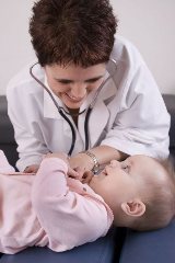 Female Doctor examining baby at cherubino health center