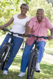 Photographs of an older couple on bicycles during a cherubino health center activity weekend