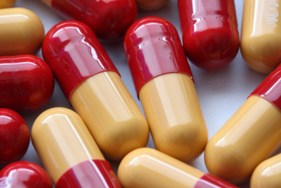 Bright red and yellow capsules filled with medication