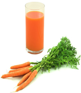 Photo Of A Glass Of Raw Carrot Juice With Raw Carrots In The Foreground Containing Live Enzymes