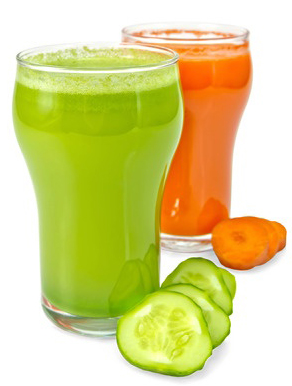 Photograph of classes of raw juice, green cucumber and orange carrot in preparation for a one day raw juice fast