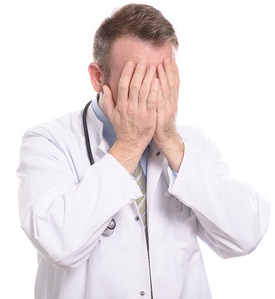 Medical Dr. with stethoscope around his neck head in hands lamenting his lack of knowledge of nutritional science