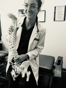 Chiropractic physician, Dr. Grace Cherubino demonstrating spinal mechanics with model spine