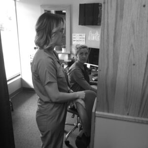 Dr Chis and Nicole at the front Desk of Cherubino Health Center