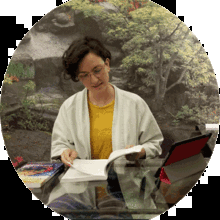 Psychotherapist Anna Cherubino reading a textbook at her desk