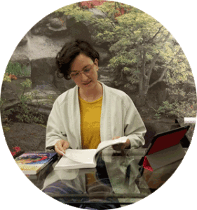 Psychotherapist Anna Cherubino reading a textbook at her desk