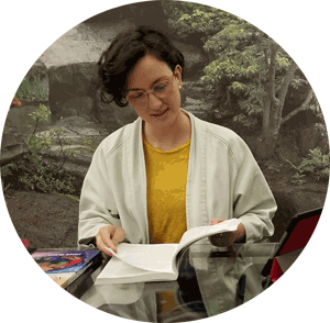 Psychotherapist Anna Cherubino reading a textbook at her desk