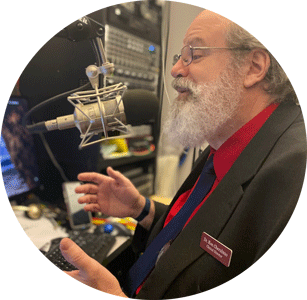 Dr Ron Cherubino speaking into a microphone in studio.