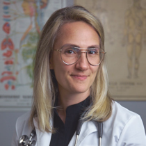 Female doctor smiling in medical office.