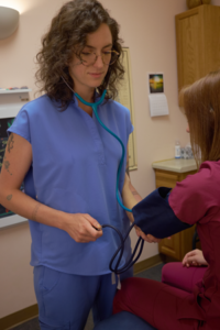 Dr Grace Cherubino taking a Blood Pressure Reading