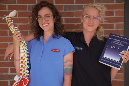 Dr-grace-Anna-pic-450x300 Dr Grace Cherubino with Anna Cherubino holding a spine and Expressive Arts Therapy book